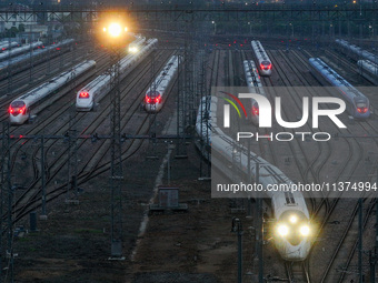 A bullet train is pulling out of the Nanjing Bullet train section in Nanjing, Jiangsu province, China, on July 1, 2024. (