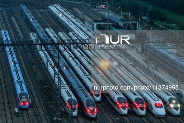 Bullet trains are stopping at the Nanjing section in Nanjing, Jiangsu province, China, in the early morning of July 1, 2024. 