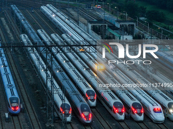 Bullet trains are stopping at the Nanjing section in Nanjing, Jiangsu province, China, in the early morning of July 1, 2024. (