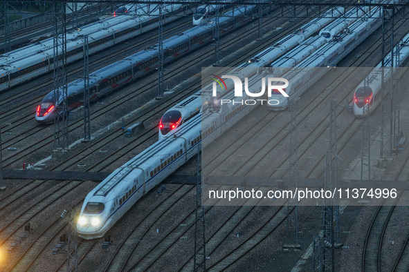 A bullet train is pulling out of the Nanjing Bullet train section in Nanjing, Jiangsu province, China, on July 1, 2024. 