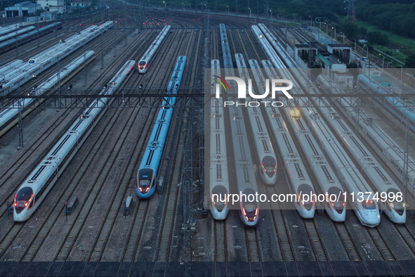 Bullet trains are stopping at the Nanjing section in Nanjing, Jiangsu province, China, in the early morning of July 1, 2024. 