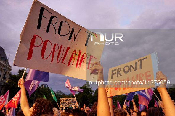 Demonstrators take part in a rally against the far right following the announcement of the results of the first round of the French parliame...