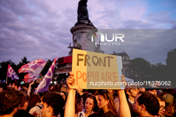 Demonstrators take part in a rally against the far right following the announcement of the results of the first round of the French parliame...