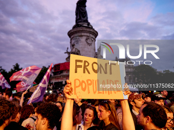 Demonstrators take part in a rally against the far right following the announcement of the results of the first round of the French parliame...