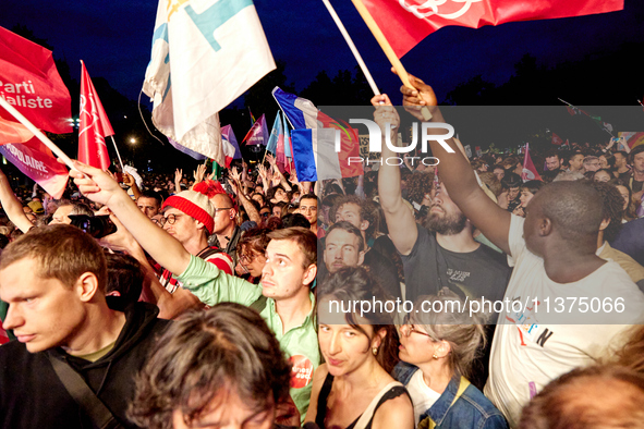 Demonstrators take part in a rally against the far right following the announcement of the results of the first round of the French parliame...