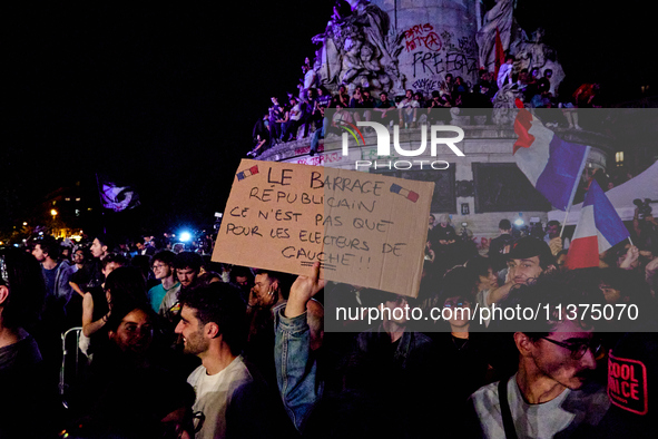 Demonstrators take part in a rally against the far right following the announcement of the results of the first round of the French parliame...