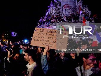 Demonstrators take part in a rally against the far right following the announcement of the results of the first round of the French parliame...