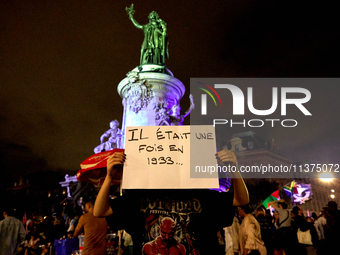 Demonstrators take part in a rally against the far right following the announcement of the results of the first round of the French parliame...