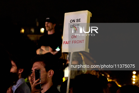 Demonstrators take part in a rally against the far right following the announcement of the results of the first round of the French parliame...