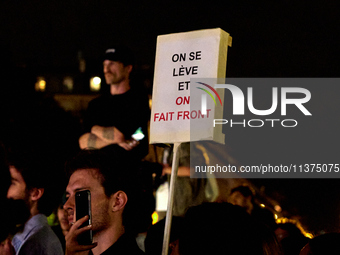 Demonstrators take part in a rally against the far right following the announcement of the results of the first round of the French parliame...