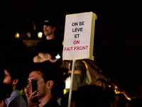 Demonstrators take part in a rally against the far right following the announcement of the results of the first round of the French parliame...