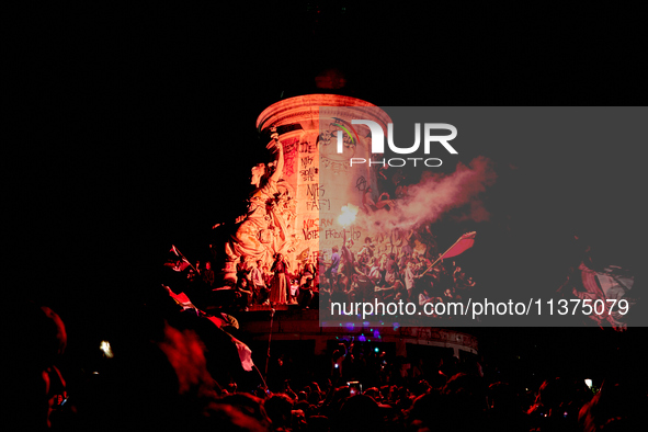 Demonstrators take part in a rally against the far right following the announcement of the results of the first round of the French parliame...