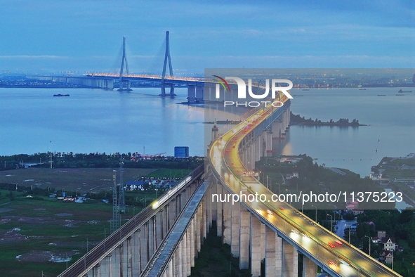 A photo taken on June 30, 2024, is showing the Shanghai-Suzhou-Nantong Yangtze River Railway Bridge in Nantong, China, on June 30, 2024. The...