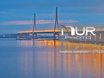 A photo taken on June 30, 2024, is showing the Shanghai-Suzhou-Nantong Yangtze River Railway Bridge in Nantong, China, on June 30, 2024. The...