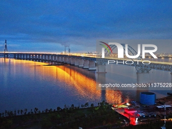 A photo taken on June 30, 2024, is showing the Shanghai-Suzhou-Nantong Yangtze River Railway Bridge in Nantong, China, on June 30, 2024. The...