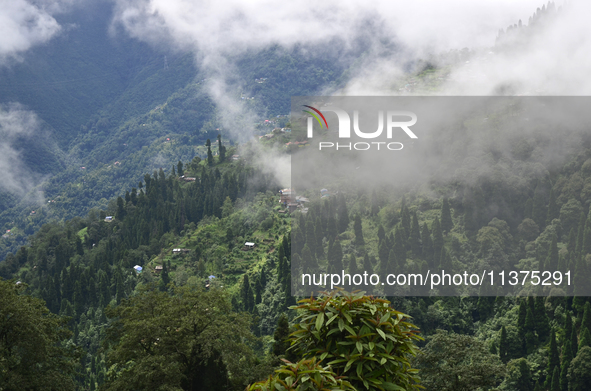 Small villages are being seen through clouds inside Singalila National Park in Darjeeling District, West Bengal, India, on June 29, 2024. 