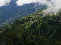 Small villages are being seen through clouds inside Singalila National Park in Darjeeling District, West Bengal, India, on June 29, 2024. (