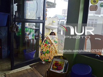 A Nepali boy is standing in front of a restaurant in Dhotrey, a village inside Singalila National Park, Darjeeling District, West Bengal, In...