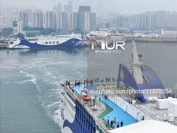 A passenger ship is sailing from Yantai to Dalian, leaving the port of Yantai in Shandong province, China, on July 1, 2024. 