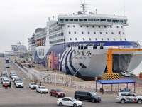 Vehicles are entering a passenger ship bound for Dalian at the port of Yantai in Yantai, China, on July 1, 2024. (