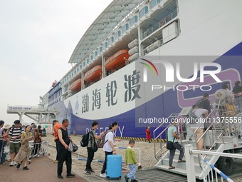 Passengers are taking a boat to Dalian at Yantai Port in Yantai, China, on July 1, 2024. (