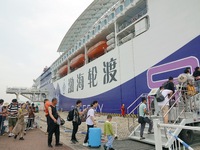 Passengers are taking a boat to Dalian at Yantai Port in Yantai, China, on July 1, 2024. (