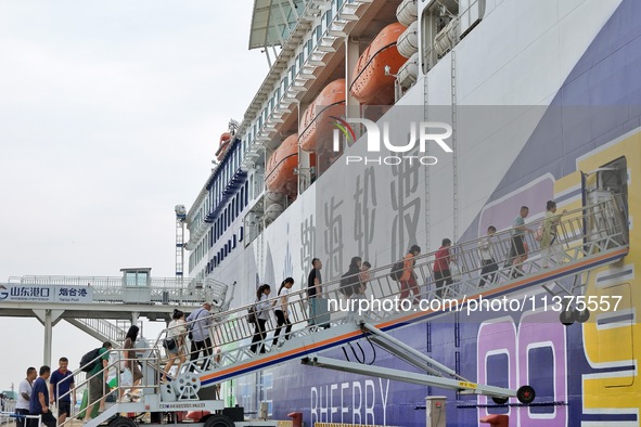 Passengers are taking a boat to Dalian at Yantai Port in Yantai, China, on July 1, 2024. 