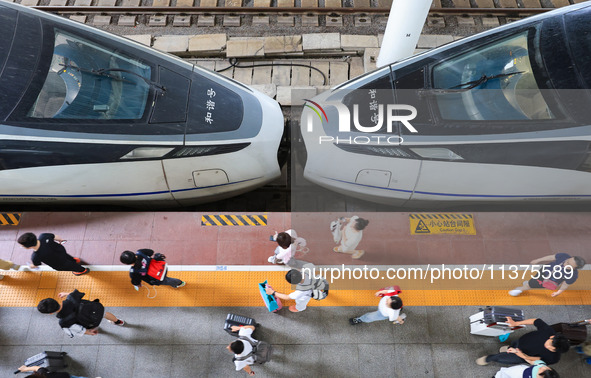 Passengers are getting off the train at Nanjing Railway Station in Nanjing, China, on July 1, 2024. 