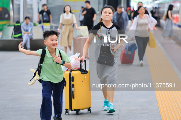 Passengers are traveling at Nanjing Railway Station in Nanjing, China, on July 1, 2024. 