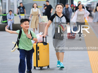 Passengers are traveling at Nanjing Railway Station in Nanjing, China, on July 1, 2024. (