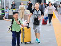 Passengers are traveling at Nanjing Railway Station in Nanjing, China, on July 1, 2024. (