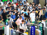 Passengers are queuing to check for tickets at Nanjing Railway Station in Nanjing, China, on July 1, 2024. (