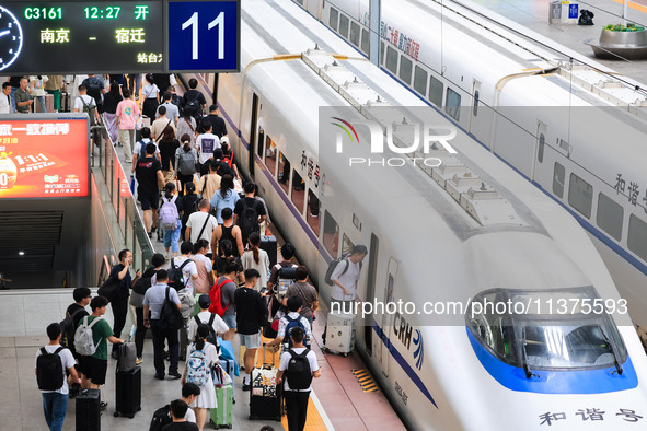 Passengers are traveling at Nanjing Railway Station in Nanjing, China, on July 1, 2024. 