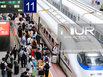 Passengers are traveling at Nanjing Railway Station in Nanjing, China, on July 1, 2024. (