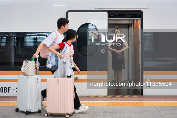 Passengers are traveling at Nanjing Railway Station in Nanjing, China, on July 1, 2024. 