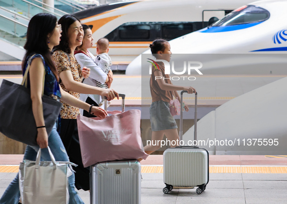 Passengers are traveling at Nanjing Railway Station in Nanjing, China, on July 1, 2024. 