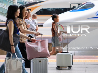 Passengers are traveling at Nanjing Railway Station in Nanjing, China, on July 1, 2024. (