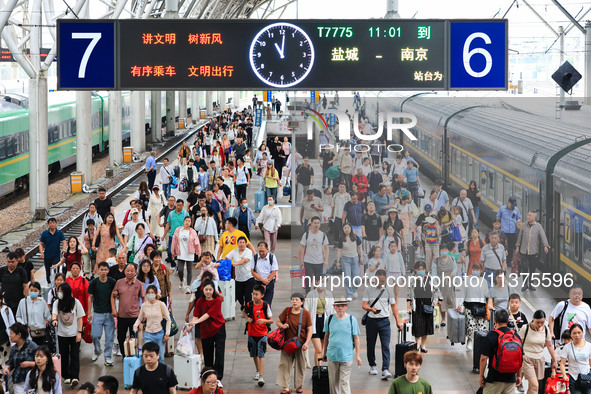 Passengers are getting off the train at Nanjing Railway Station in Nanjing, China, on July 1, 2024. 