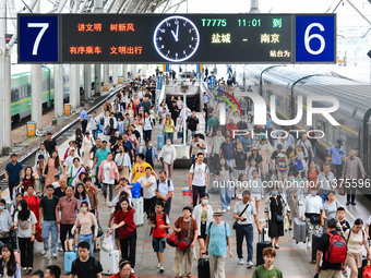 Passengers are getting off the train at Nanjing Railway Station in Nanjing, China, on July 1, 2024. (