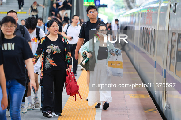 Passengers are traveling at Nanjing Railway Station in Nanjing, China, on July 1, 2024. 