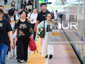 Passengers are traveling at Nanjing Railway Station in Nanjing, China, on July 1, 2024. (