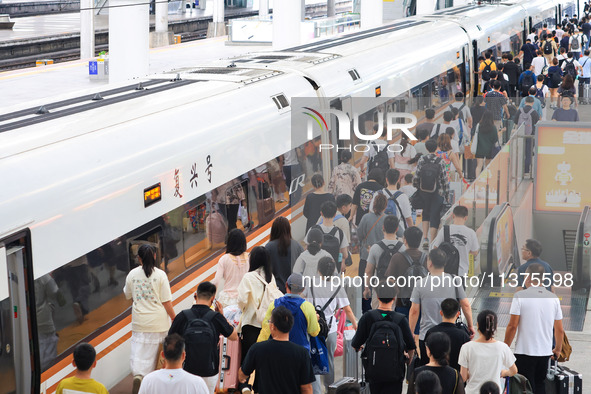 Passengers are traveling at Nanjing Railway Station in Nanjing, China, on July 1, 2024. 