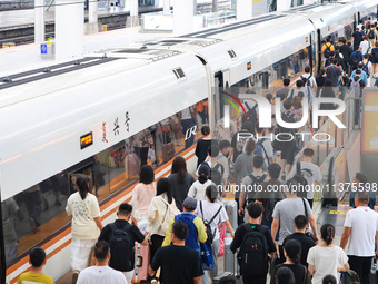 Passengers are traveling at Nanjing Railway Station in Nanjing, China, on July 1, 2024. (