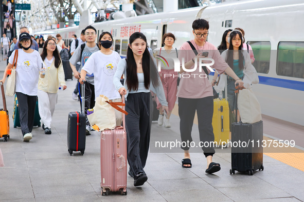 Passengers are traveling at Nanjing Railway Station in Nanjing, China, on July 1, 2024. 