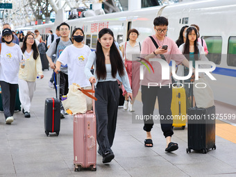 Passengers are traveling at Nanjing Railway Station in Nanjing, China, on July 1, 2024. (