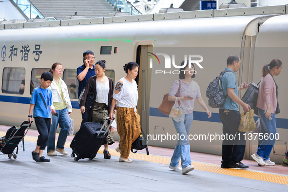 Passengers are traveling at Nanjing Railway Station in Nanjing, China, on July 1, 2024. 