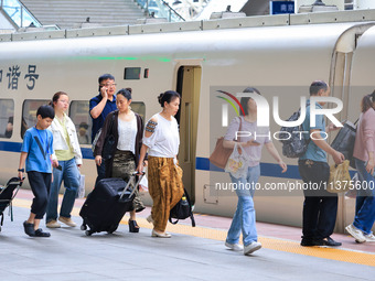 Passengers are traveling at Nanjing Railway Station in Nanjing, China, on July 1, 2024. (