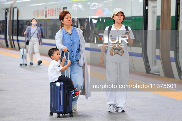 Passengers are traveling at Nanjing Railway Station in Nanjing, China, on July 1, 2024. 