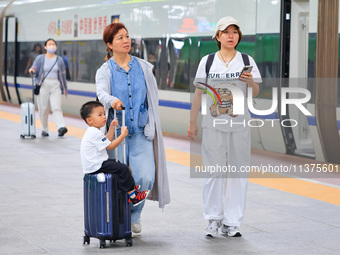 Passengers are traveling at Nanjing Railway Station in Nanjing, China, on July 1, 2024. (