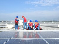 Power technicians are inspecting the operation of rooftop solar photovoltaic modules in Chuzhou, China, on June 30, 2024. (